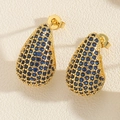 Detailed macro view of gold-plated teardrop earrings pavé set with blue zircon stones - Royal Blue Zirconia