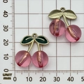 Pink acrylic cherry pendant with gold stem shown on a millimeter grid for size scaling - 1Pc Plated Transparent Rose Red Large Cherry (27x23mm)