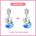 Luminous Aquarius zodiac charm in silver and blue showing light in the dark effect - Aquarius