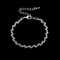 Macro detail of silver wave-shaped zircon bracelet with lobster clasp and chain - 785 Bracelet