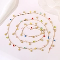 Detail of gold chain necklace with white daisies and colorful star shaped bead accents - White Daisy Star Heart Chain