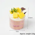 Pink and cream faux mousse cup dessert with mango pieces and white label decoration - Mango Biscuit Cake