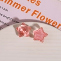 Close-up of translucent pink star resin charms for DIY jewelry and phone case crafts - Deep Pink