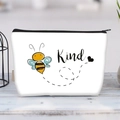 White canvas makeup bag with cartoon bee and Kind text on light wood surface - Busy Little Bee Kind(jiayingljb26)