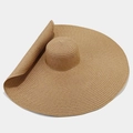 Detailed view of wide-brim straw hat featuring natural khaki fiber weave and flexible texture - One Size / Khaki