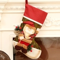 Christmas stocking with 3D Santa Claus and burlap gift bag on a fireplace mantel - Santa Claus