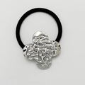 Elastic black hair tie featuring a silver textured metal clover-shaped charm decoration - Shiny Silver - Textured Clover