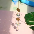 Golden suncatcher with moon, star motifs and crystal prisms reflecting rainbow light - Size 21