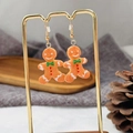 Handmade gingerbread man resin earrings with festive white frosting and gold hooks - Gingerbread Man