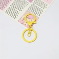 Detail of bright yellow lacquered metal lobster clasp and round keyring accessories - Yellow