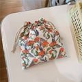 Dettaglio della borsa in cotone con coulisse, stampa floreale stile pittura a olio e corda - Base bianca con grandi fiori arancioni