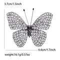 Alloy butterfly brooch with rhinestones and dimensions 3.7cm x 4.4cm on white background - White