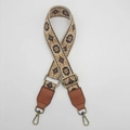 Close-up of ethnic woven pattern canvas strap with bronze metal hooks and leather ends - Beige Background Coffee Edge Brown Leather [Rich Flower]