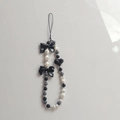 Chic black and white beaded phone strap with ribbon bow and heart-shaped charms - Black Bow Phone Chain