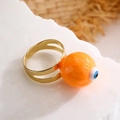 Macro detail of gold-plated adjustable ring featuring orange sphere with blue evil eye - Adjustable Open / Orange (13416)