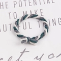 Close-up of handmade braided elastic hair tie in green, grey, and white on a card - Dark Green-Grey-Cream