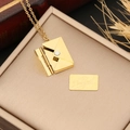 Golden envelope locket necklace with I love you card on a minimalist jewelry box - LOVE Lettering / Gold