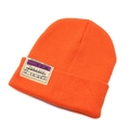 Detail of orange beanie featuring boarding pass patch with HKG to NYC flight design - Orange Red