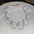 Detail of floral pearl necklace with sparkling rhinestones on a white plate - Pearl Flower Style (HN11052) / Silver