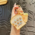Cute toast bread shape handheld pop fidget toy keychain in warm yellow and beige colors - Toast
