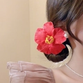 Detailed view of a realistic red hibiscus flower hair clip with yellow stamen on elegant bun - 14# Duckbill Clip - Bright Red Hibiscus Style