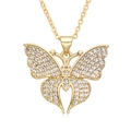 Macro shot of gold-plated butterfly pendant with sparkling zircon crystals on fine chain - F238