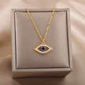 18k gold-plated Evil Eye necklace with blue zircon pendant on beige silk surface - Gold Dark Blue Evil Eye Necklace (G31503893/1)