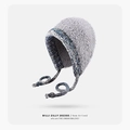 Grey plush knit trapper hat with blue and white woven earflaps and pompom ties - Gradient-Grey