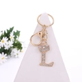 Golden keychain featuring a sparkling crystal crown and letter L on a white stand - Letter L / Gold