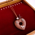 Close-up of heart-shaped lava stone pendant with silver cross details in red velvet box - Necklace-Brown-Silver (Cross Horse Style)