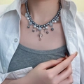 Gray and blue beaded necklace with a silver cross pendant worn by a female model - Multi-Color Bead Cross Pendant Necklace (X4136B)