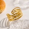 Gold layered open bangle with irregular wave texture and matte finish on glass tray - Gold Multi-layer Hammered