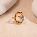 Detail of gold irregular lava-style ring featuring a floating round cut zircon stone - Gold Round