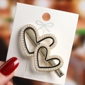 Detailed view of elegant double heart hair clip with white pearls and gold metal base - No.10 Pearl Double Heart Hair Clip