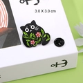Cartoon black cat enamel pin with pink flowers and green leaves, size 3.0 X 3.0 cm - Style A Black Cat