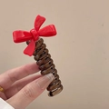 Elegant amber spiral hair claw clip featuring a handmade red bow decoration - Red [Candy Bow]