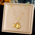 Macro detail of gold starfish and shell charms with colorful crushed stone chain - Starfish Shell With Colorful Stones (N3473)