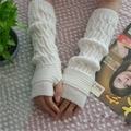 Detailed close-up of white cable-knit fingerless arm warmers with ribbed elastic cuffs - White