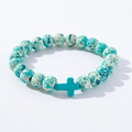 Detail of blue turquoise cross bead and speckled round stones on the beaded bracelet - Blue White Spotted Blue Cross Wood Bracelet