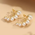 Elegant gold curved earrings featuring five white pearls in a gradient arch design - Multi-pearl Earrings
