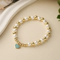 Elegant gold bead and faux pearl bracelet with a heart-shaped blue zircon pendant charm - Light Blue Stone Heart Pendant