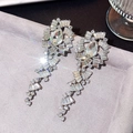 Macro view of long tassel earrings with sparkling pear-cut rhinestones and silver finish - White Gold Geometric Radiant Tassel (997)