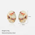 Detail of oval stainless steel earrings with gold dragonfly relief and enamel inlay - Gold & Red Purple Dragonfly