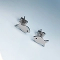 Close-up of cute silver fish stud earrings with high-polished metallic finish - Silver Fish Stud Earrings