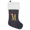 Detail of grey velvet Christmas stocking with white plush cuff and gold glitter letter M - Letter M