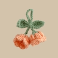 Macro detail of handmade crochet lily of the valley pendant with orange pink petals - Orange