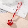 Close-up of red lucky cat bell pendant with gold Fortune script and red cord strap - Red Lucky