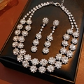 Detailed view of silver flower tassel jewelry set with necklace and earrings in black box - Silver-White