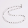 Detailed close-up of white round pearls with silver beads and lobster clasp fastener - Silver Color Necklace (6mm)