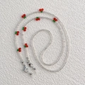 Detail of beaded glasses chain with red cherries, green leaves and silver metal lobster clasps - Transparent with Red Cherry